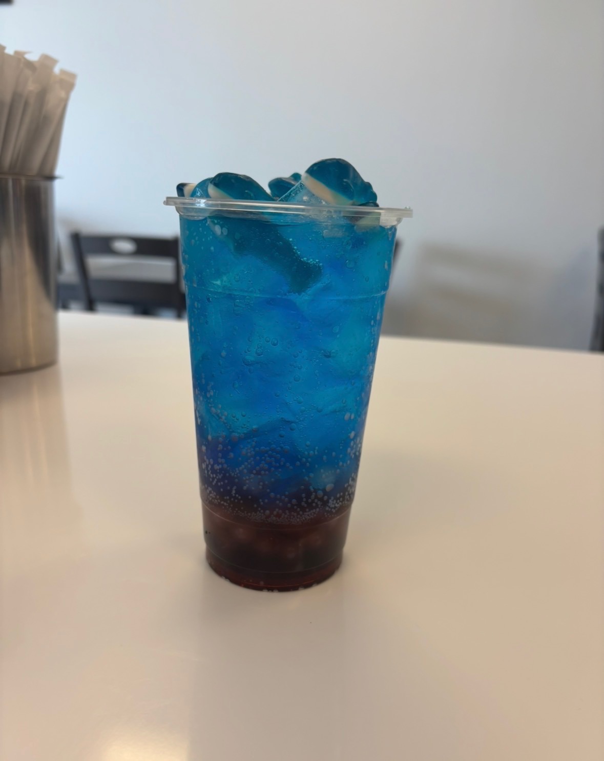 Tall iced brown sugar boba milk tea with chewy tapioca pearls in a clear glass cup at Jayweezys coffee shop