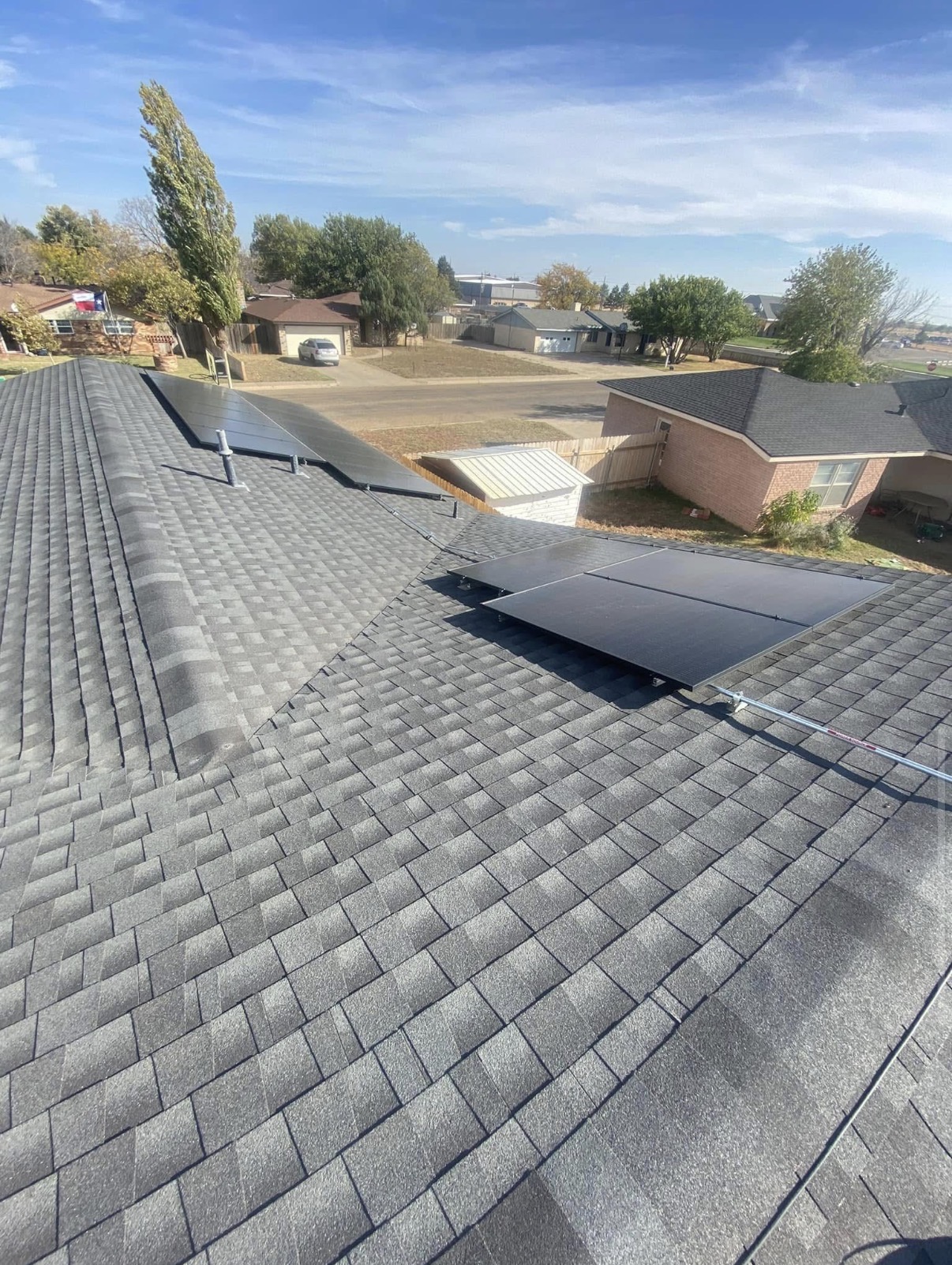 Najera Roofing newly installed high-definition architectural shingle roof on a large suburban home