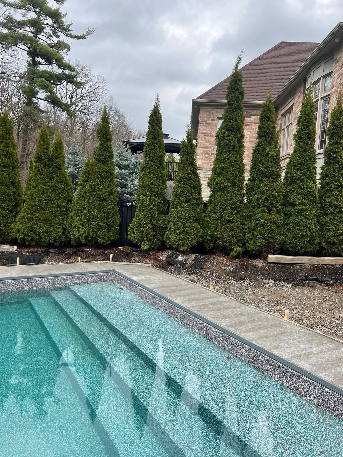 In-ground vinyl liner pool installation with new concrete decking