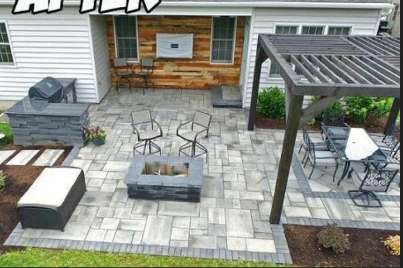 After: finished stone patio with pergola, fire pit, and outdoor kitchen