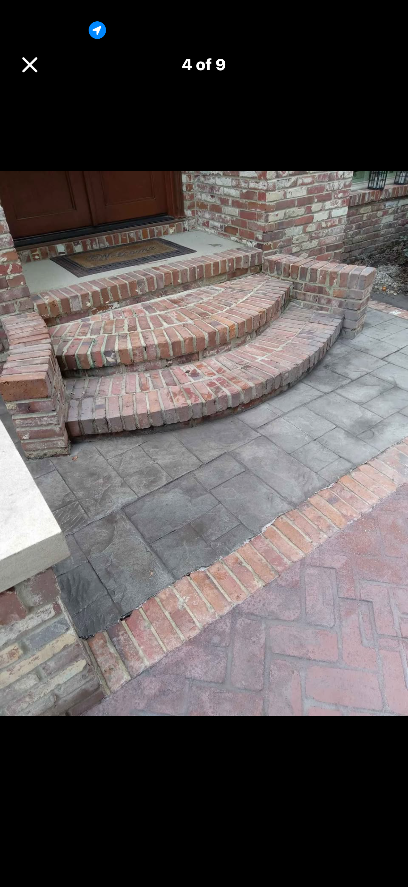Custom stamped concrete patio with intricate ashlar slate patterns surrounding a fire pit