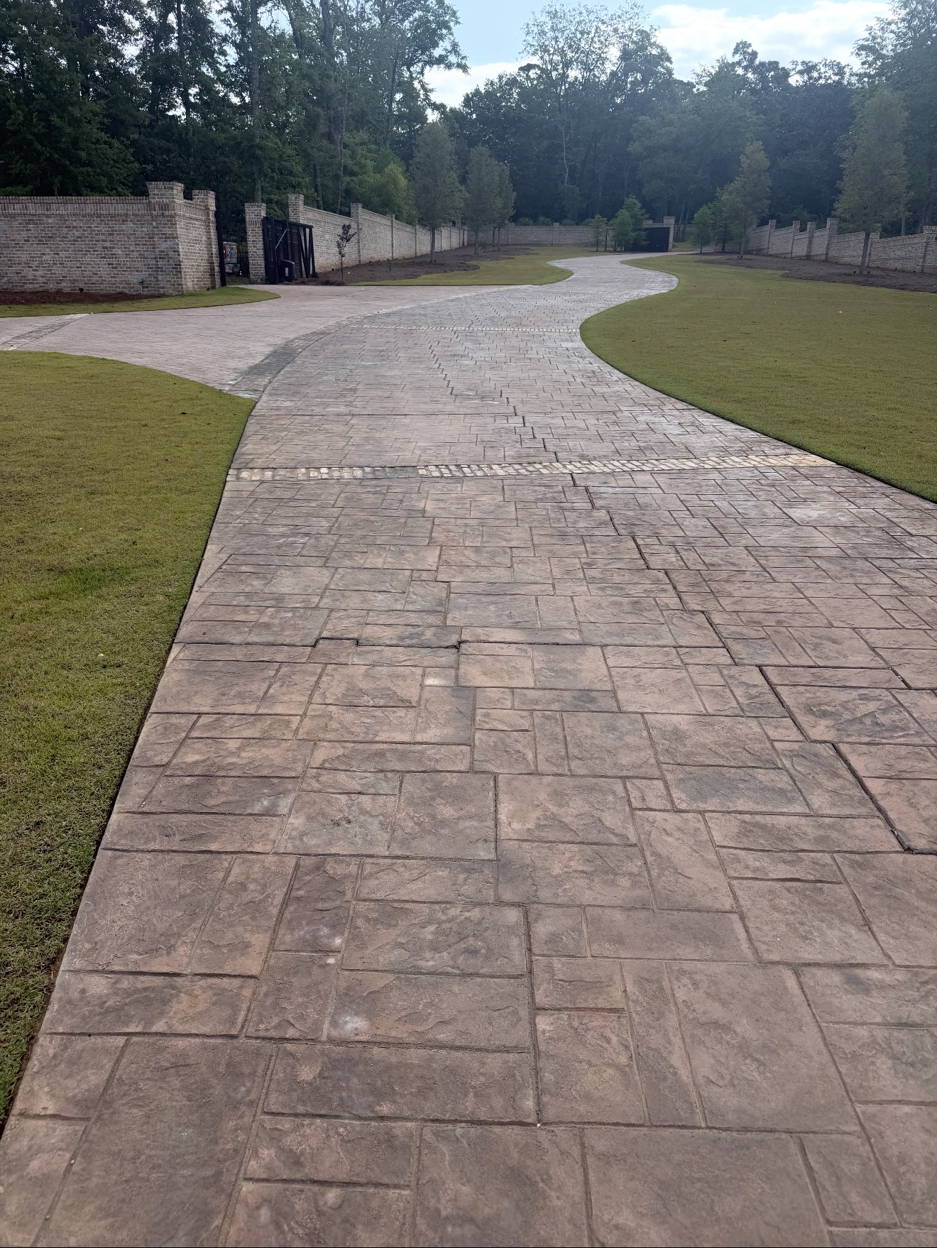 Professionally finished concrete driveway in front of a modern home
