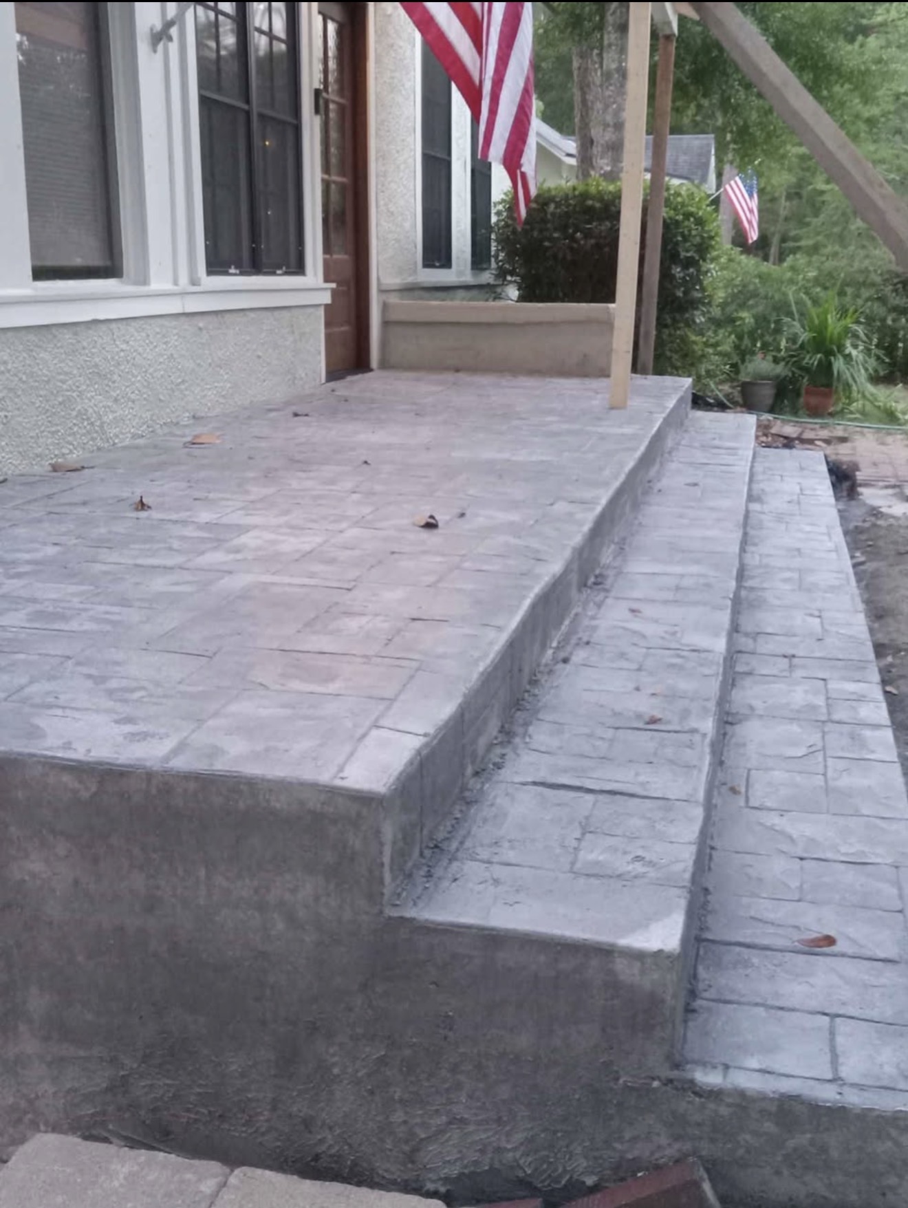 Freshly poured concrete foundation with rebar reinforcement for a new custom home build