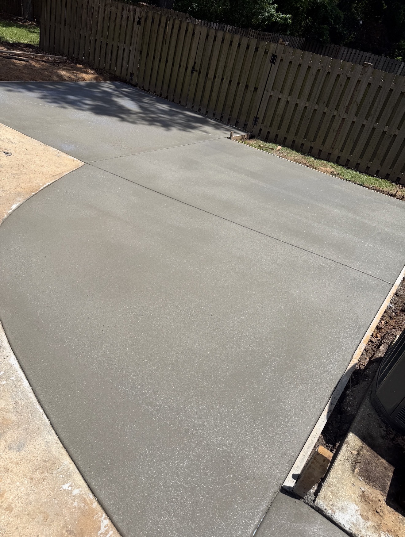 Decorative textured concrete pool deck surrounding a luxury backyard swimming pool