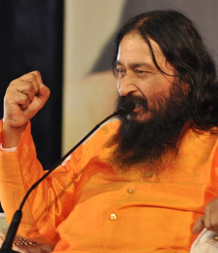 Reverent portrait of spiritual master Shri Ashutosh Maharaj Ji in saffron robes with serene expression