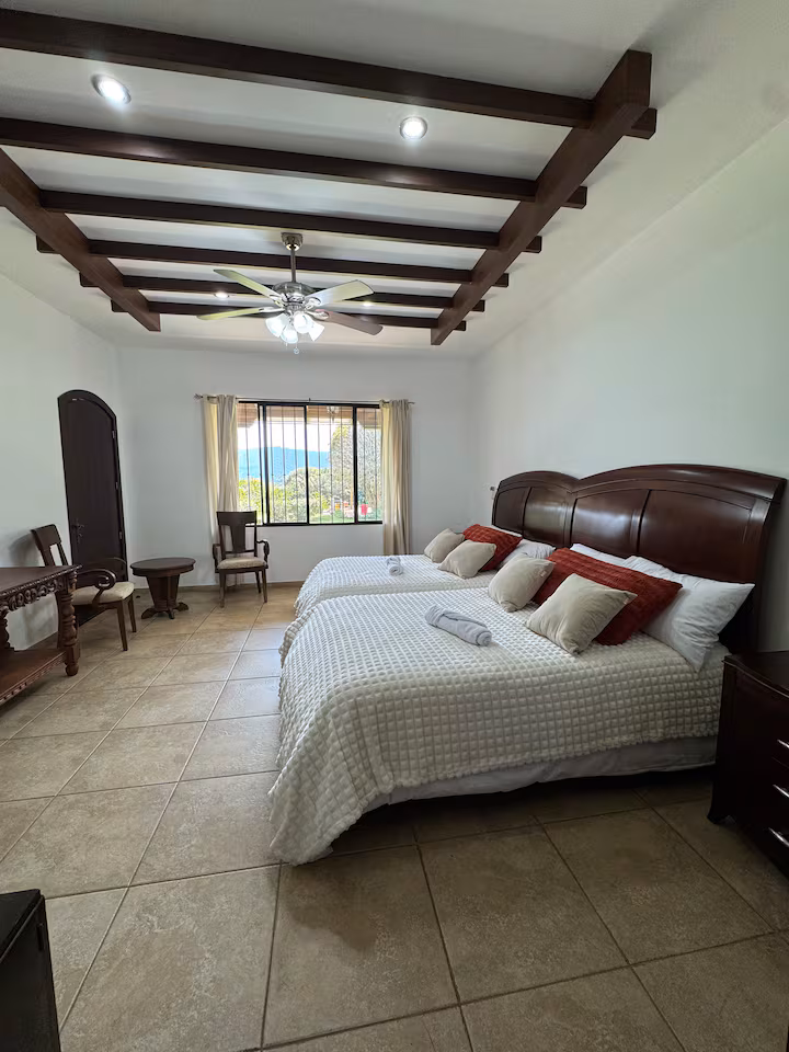 Cozy bedroom with a wooden bed frame and crisp white linens in a farmhouse
