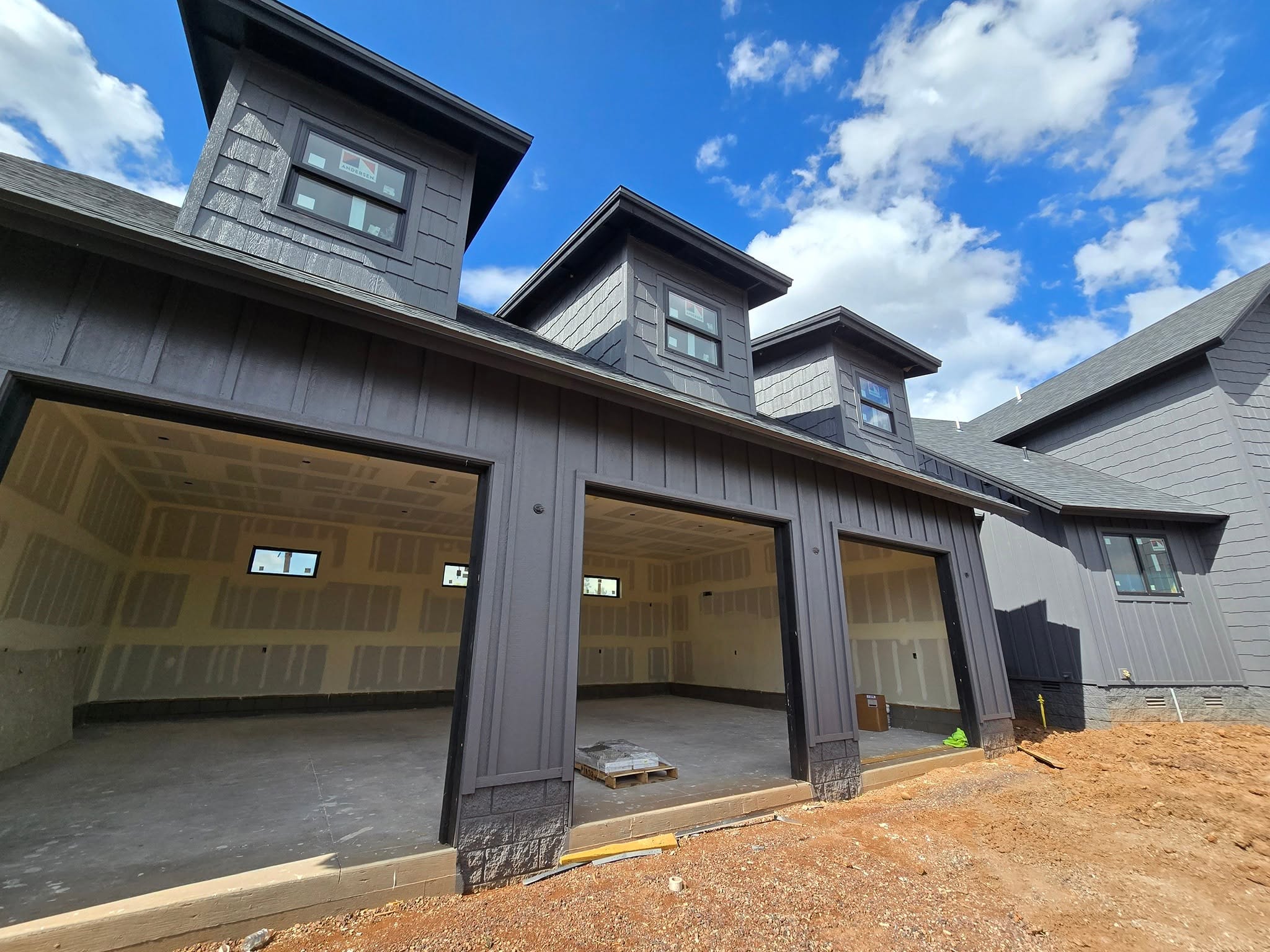 Custom color exterior transformation project showing before and after quality of a fully repainted mountain home