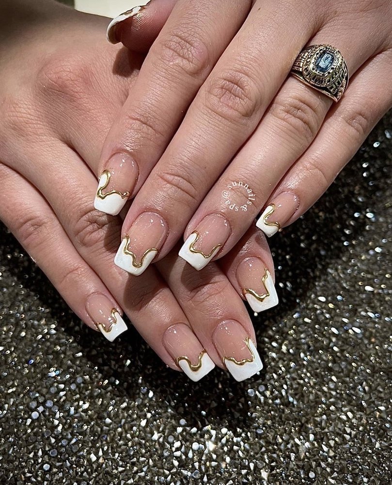 Elegant nude gel manicure featuring intricate hand-painted white marble swirl artistry on coffin-shaped nails with glossy top coat finish