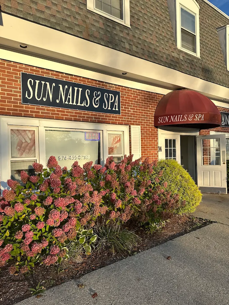 Elegant storefront exterior of Sun Nails and Spa salon with modern signage and welcoming entrance