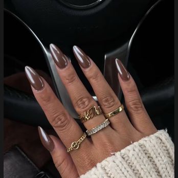 Luxurious champagne gold glitter ombre manicure featuring hand-set iridescent pearl embellishments on oval-shaped nails with soft fade effect