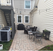 Transformed lush green manicured lawn with fresh mulch and clean edging after landscaping