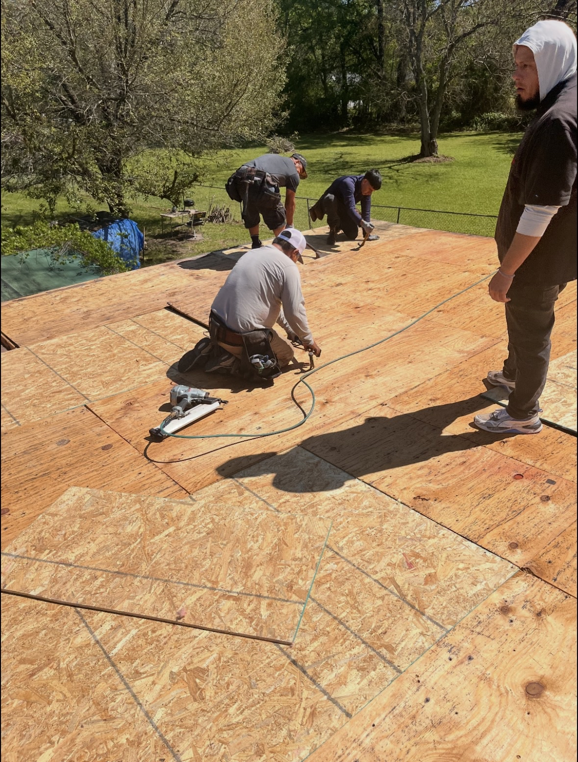 Crew installing shingles