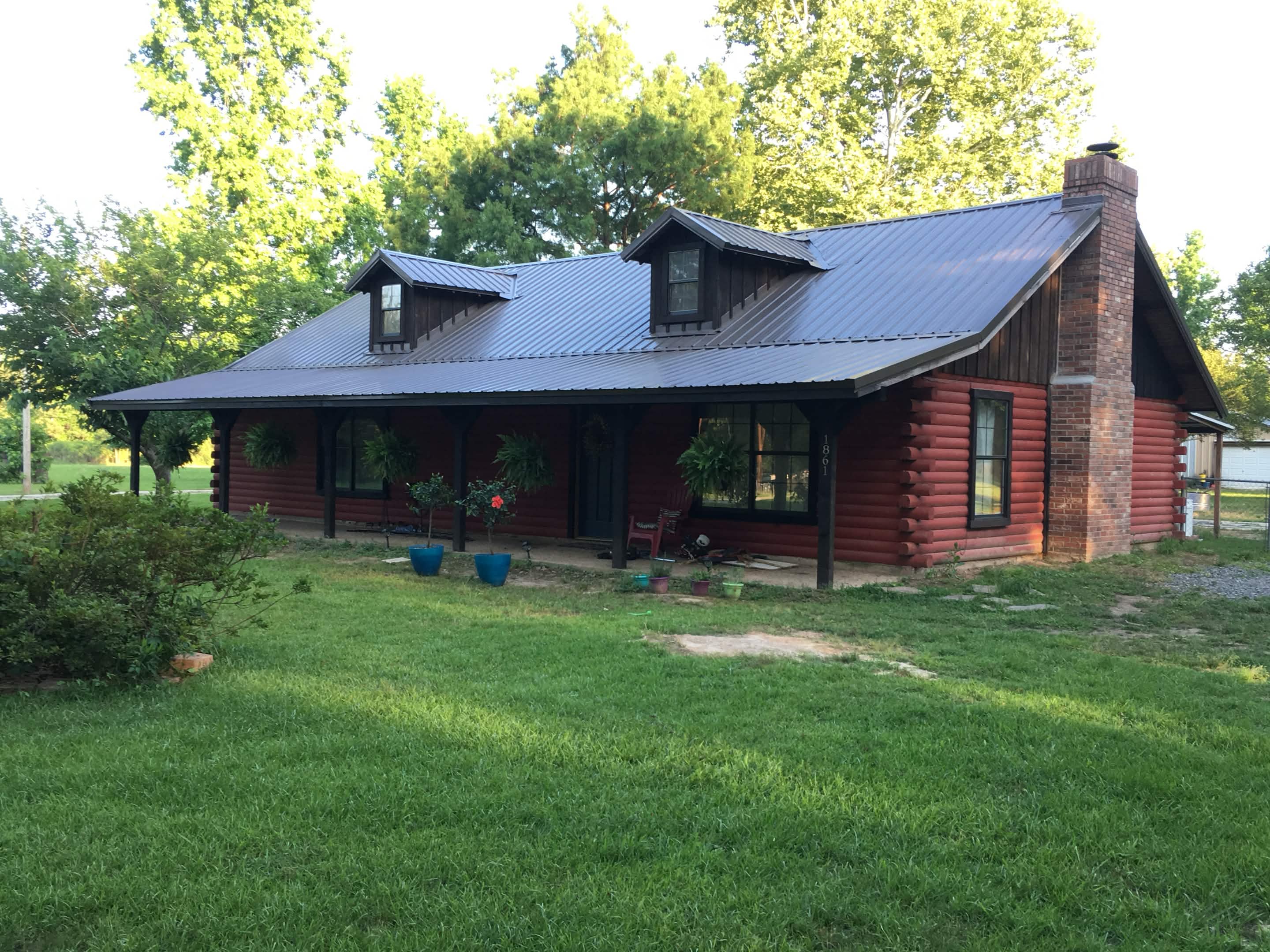 New metal roof with clean ridge line and uniform panel alignment on residential property