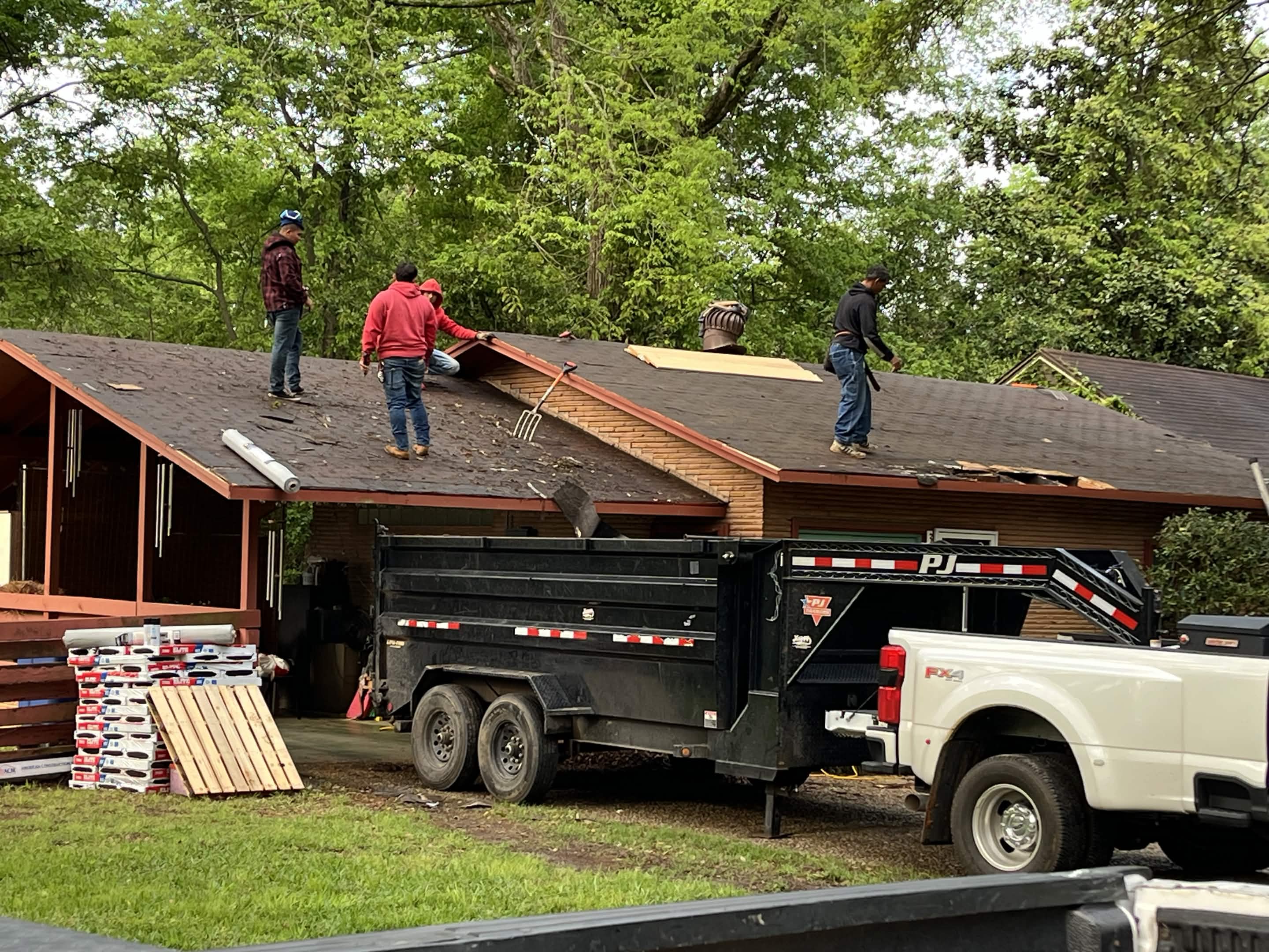 Brown Home Improvement roofing crew installing new asphalt shingles on residential roof in Louisiana