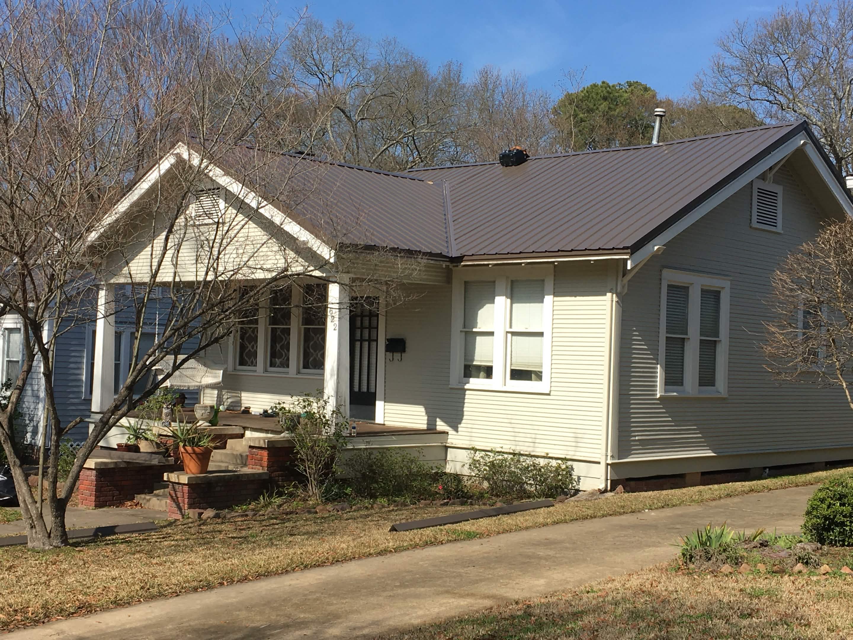 Completed asphalt shingle roof replacement on family home with sharp clean lines