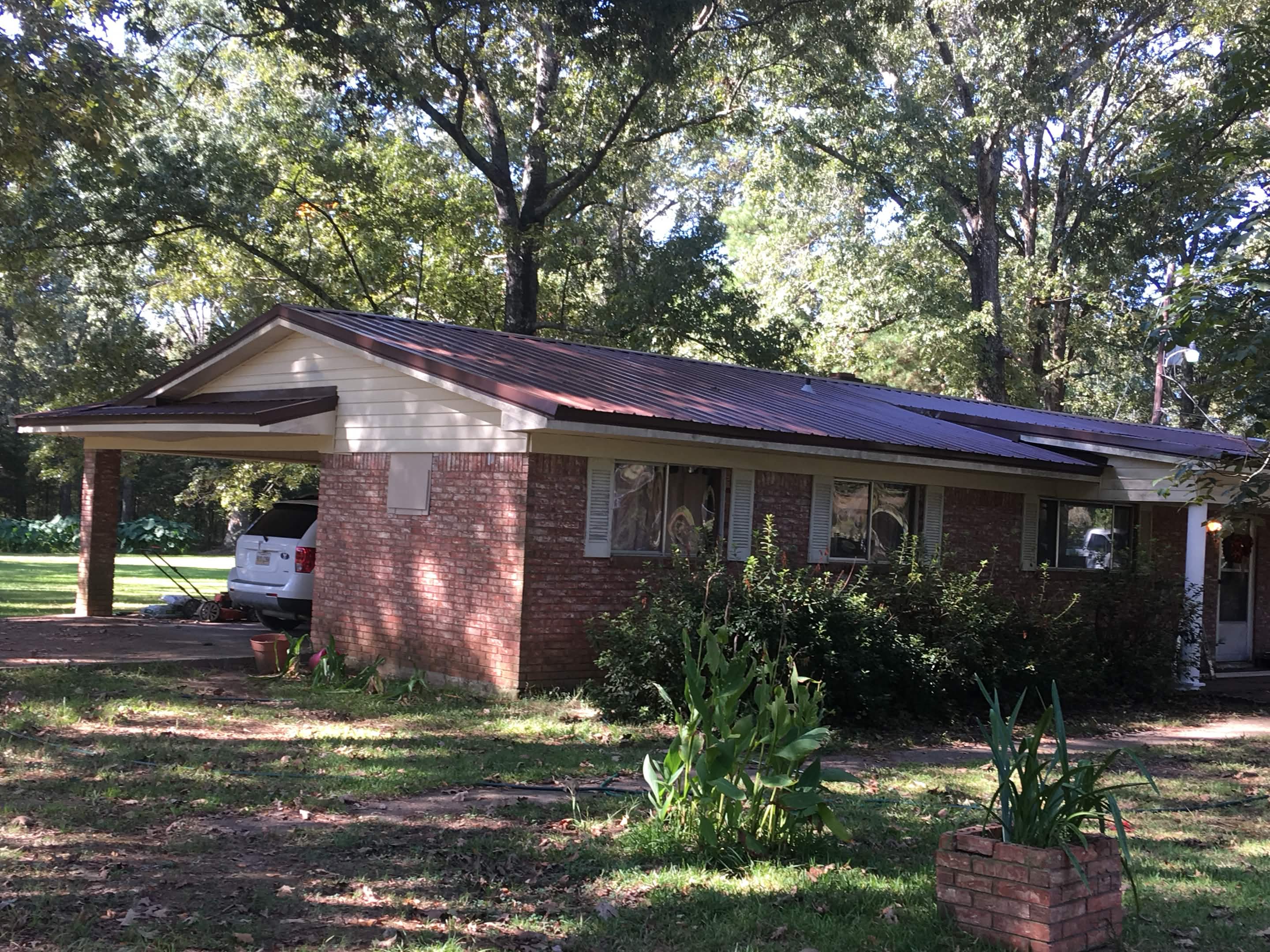 Newly installed shingle roof with ridge cap and uniform shingle pattern on a residential home