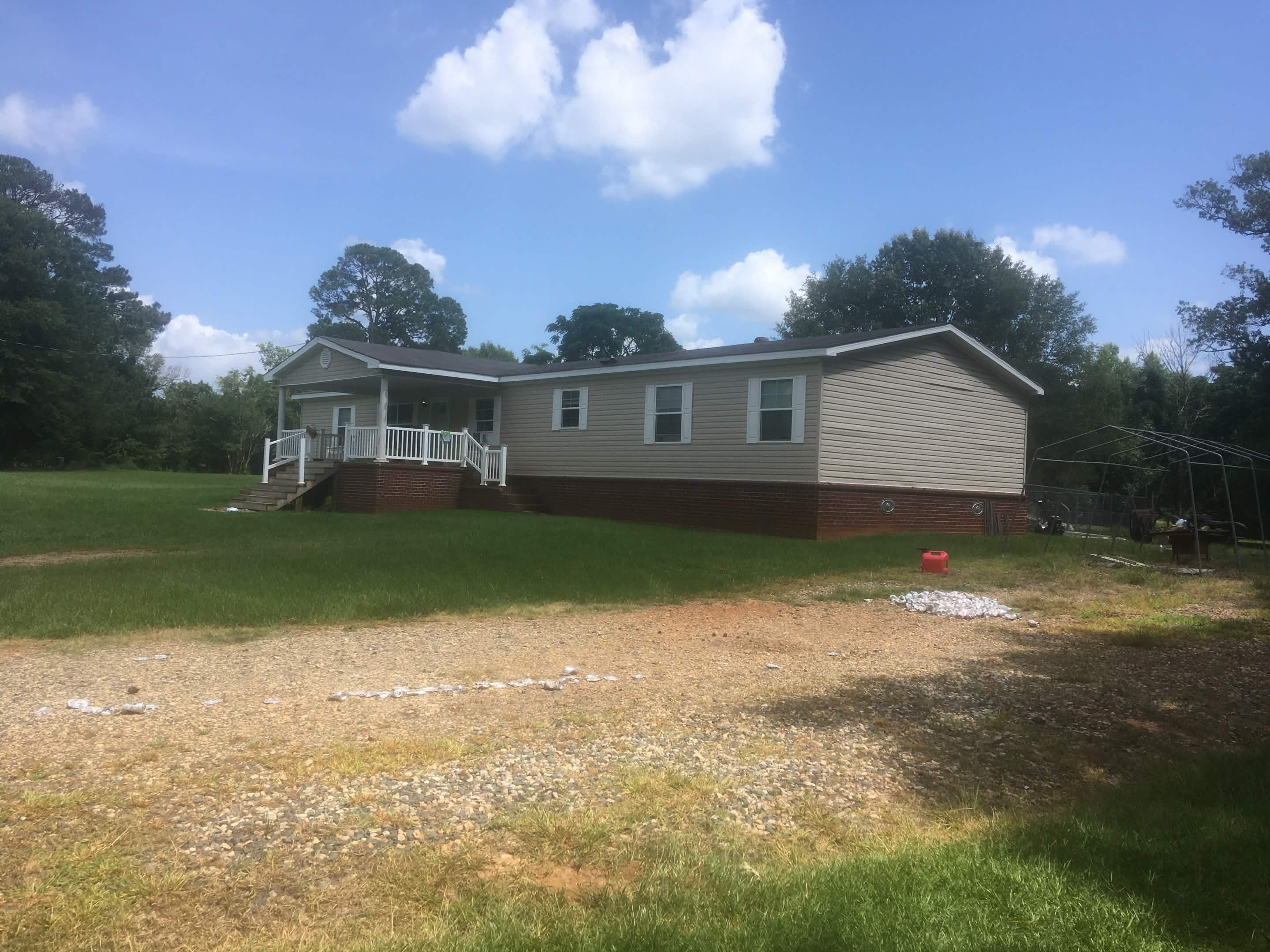 Completed corrugated metal roof installation on country home with durable galvanized finish