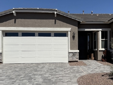 Freshly painted Phoenix stucco home exterior with warm terracotta trim and desert landscaping