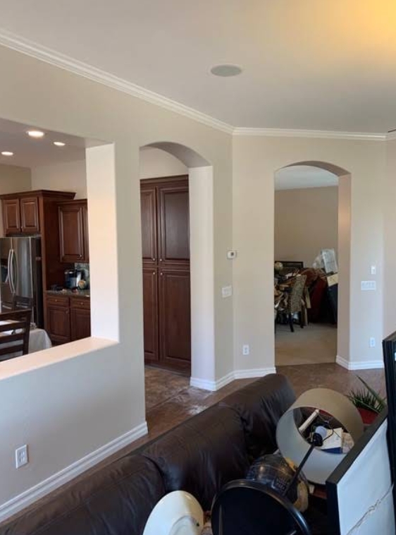 Freshly painted living room interior with warm neutral walls and white trim in a Phoenix home