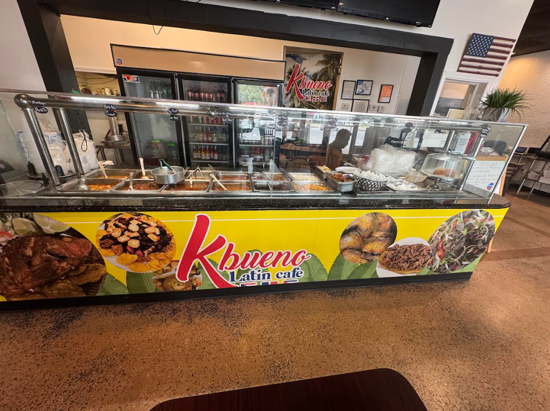 Vivid spread of authentic Cuban, Dominican, and Puerto Rican dishes like mofongo, plantains, and roast pork on a rustic wooden table