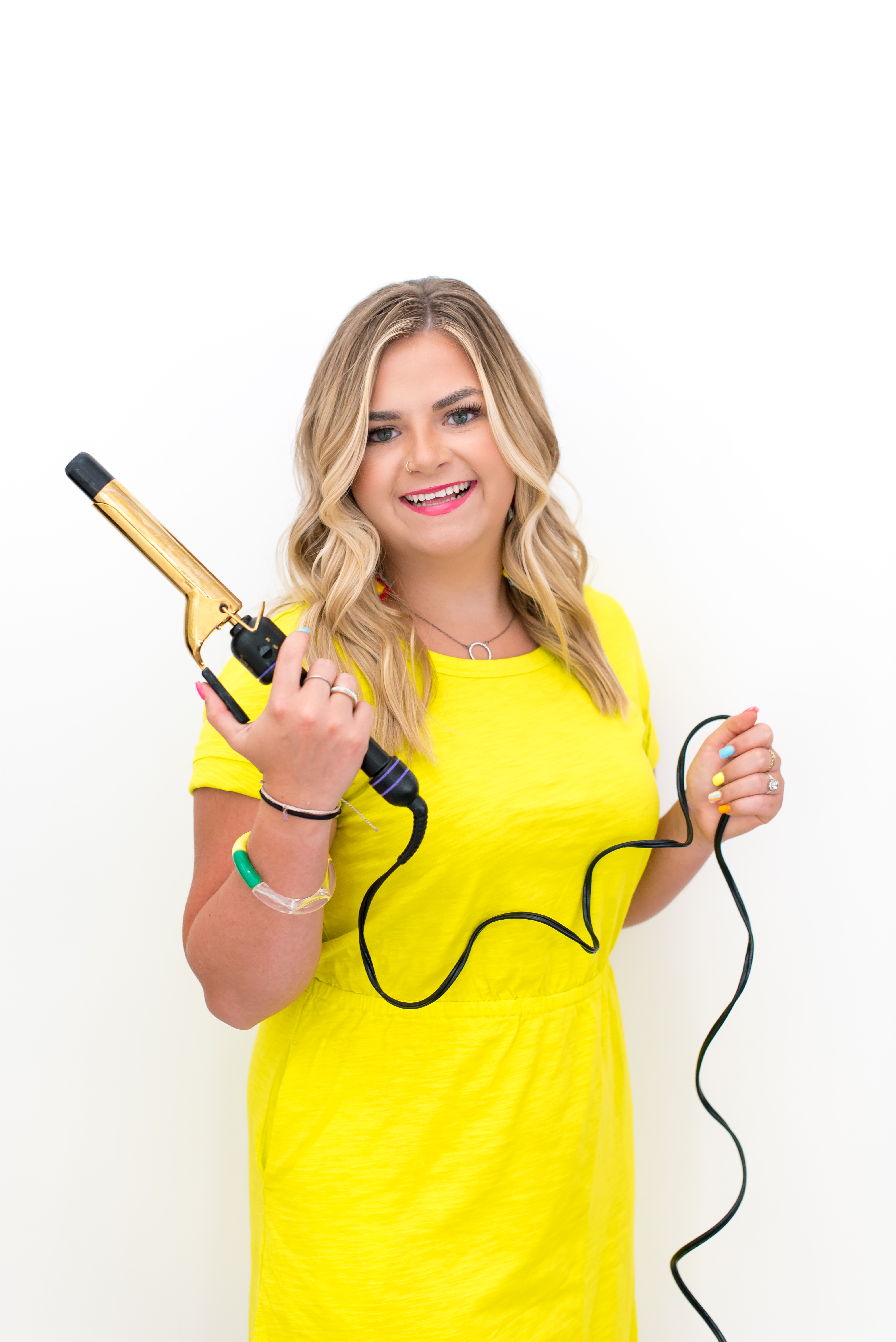 Professional headshot of Kayla the stylist smiling in salon