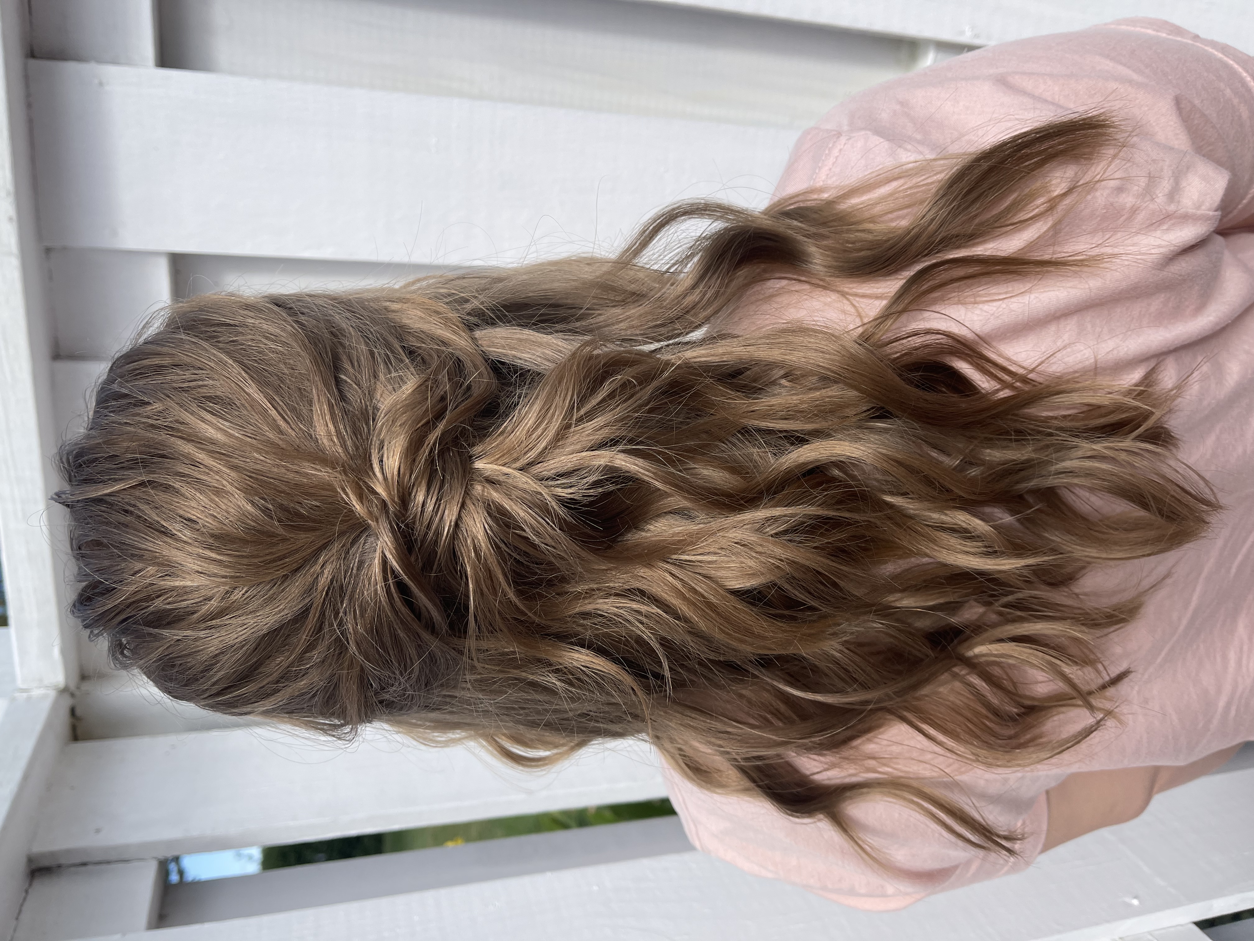 Elegant bridal hair styling with soft curls and delicate veil on radiant bride