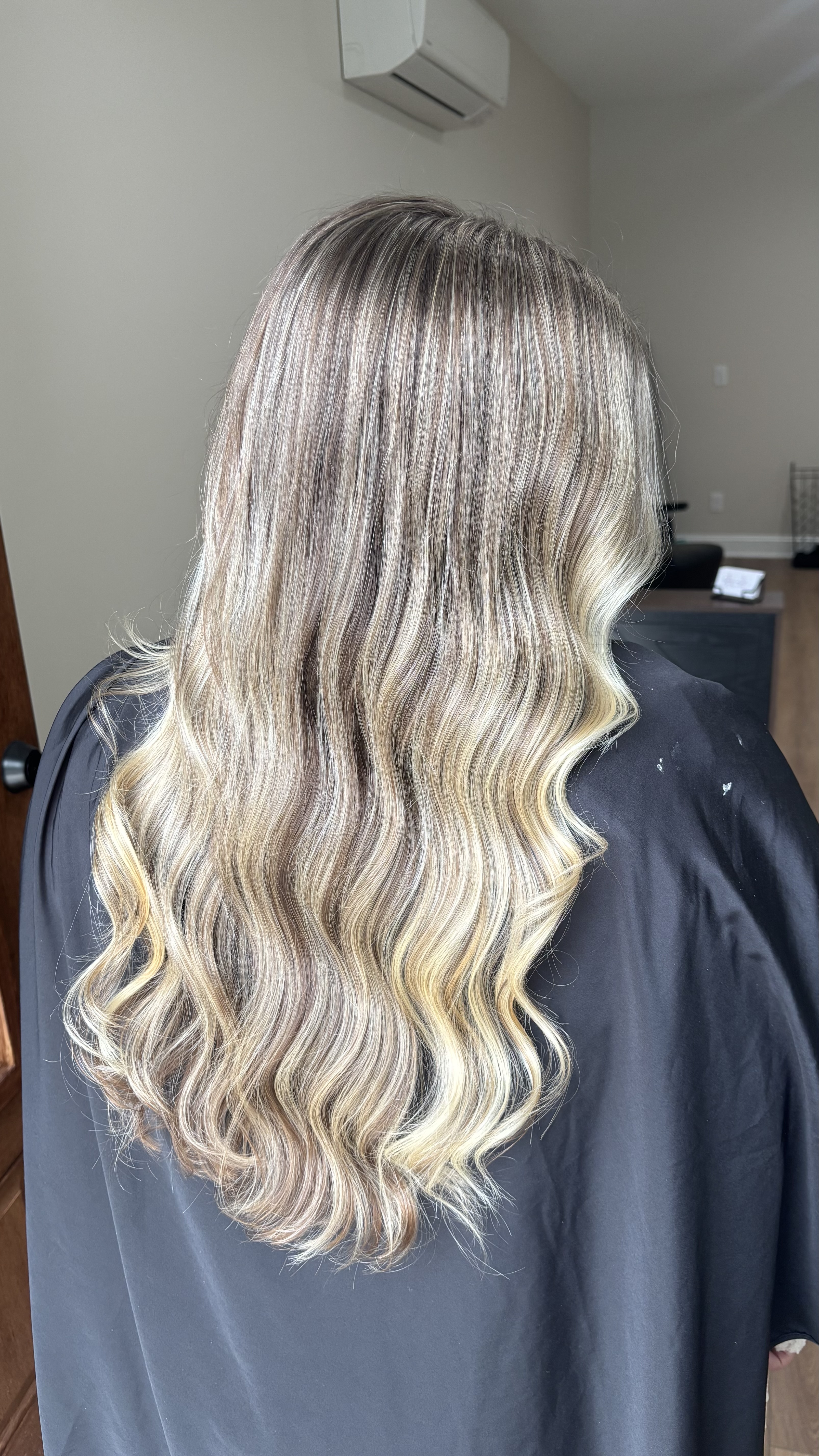 Luxurious balayage blonde hair color transformation with seamless dimensional highlights