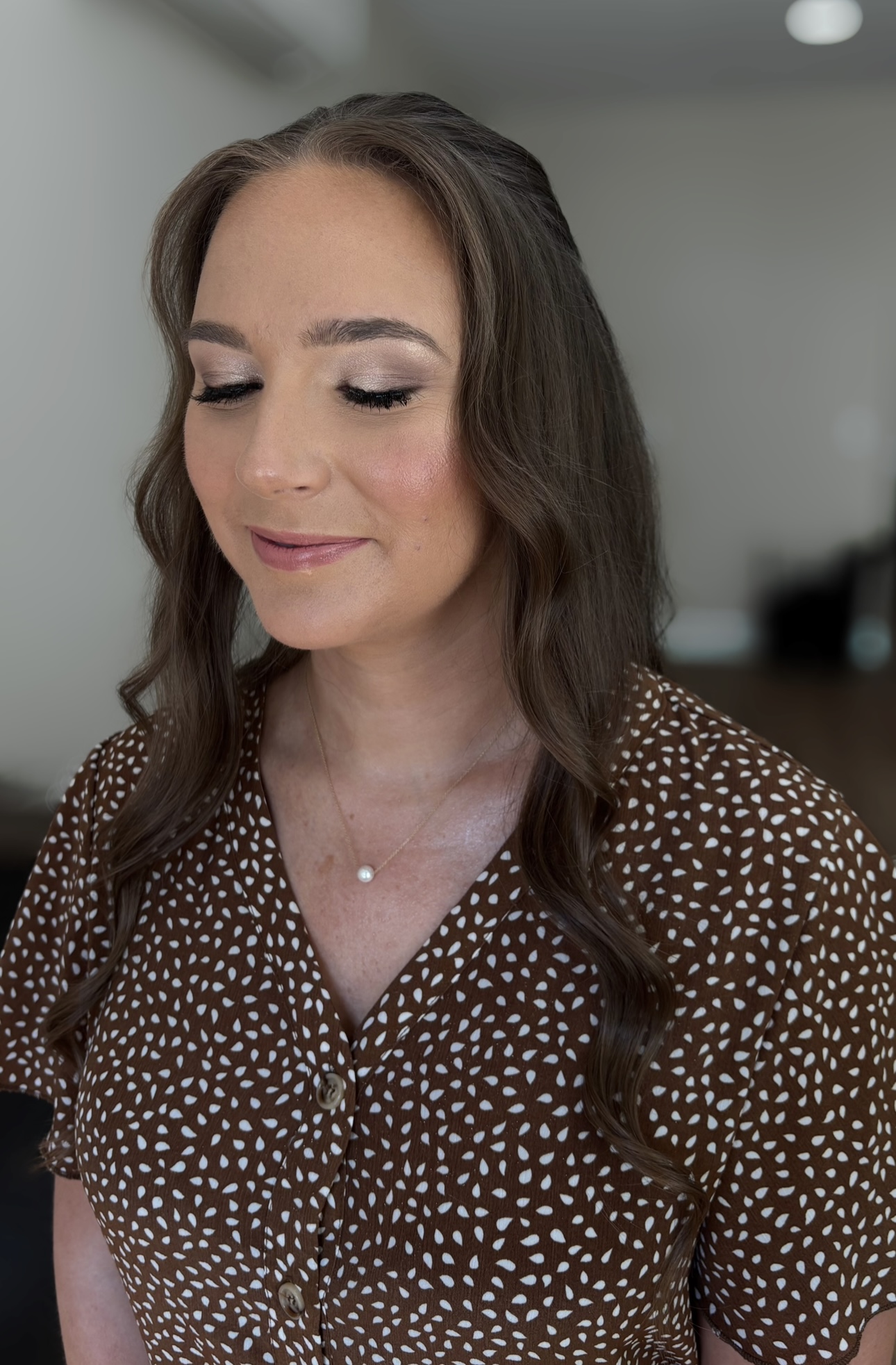 Modern layered haircut and voluminous blowout styling with glossy finish
