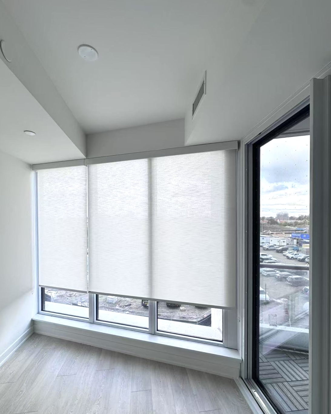 Elegant modern Toronto living room featuring custom motorized zebra blinds filtering soft natural light across hardwood floors