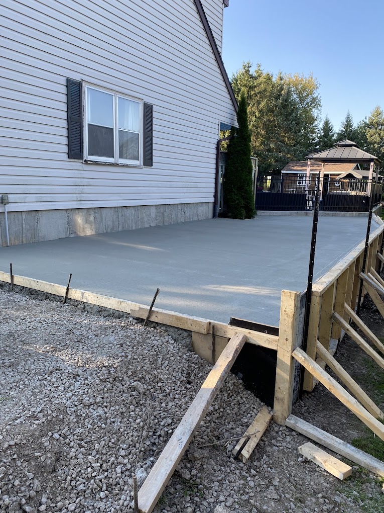 Professional concrete driveway and patio installation by Reimer Works Contracting