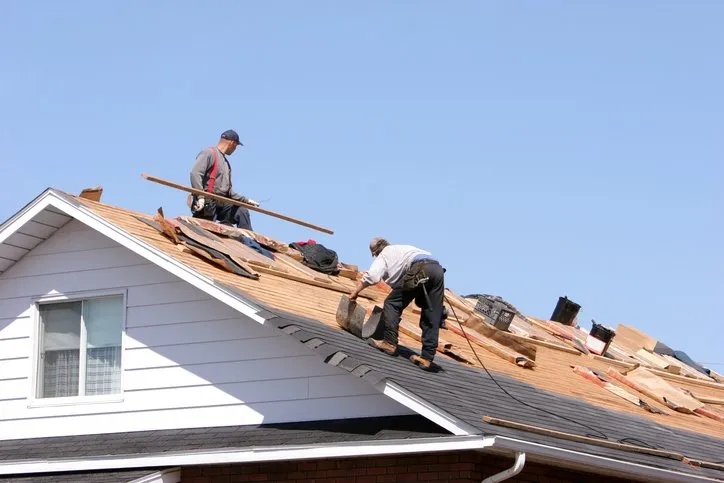 The SantosRise LLC crew working on roofing, gutters, and siding installation for a residential home