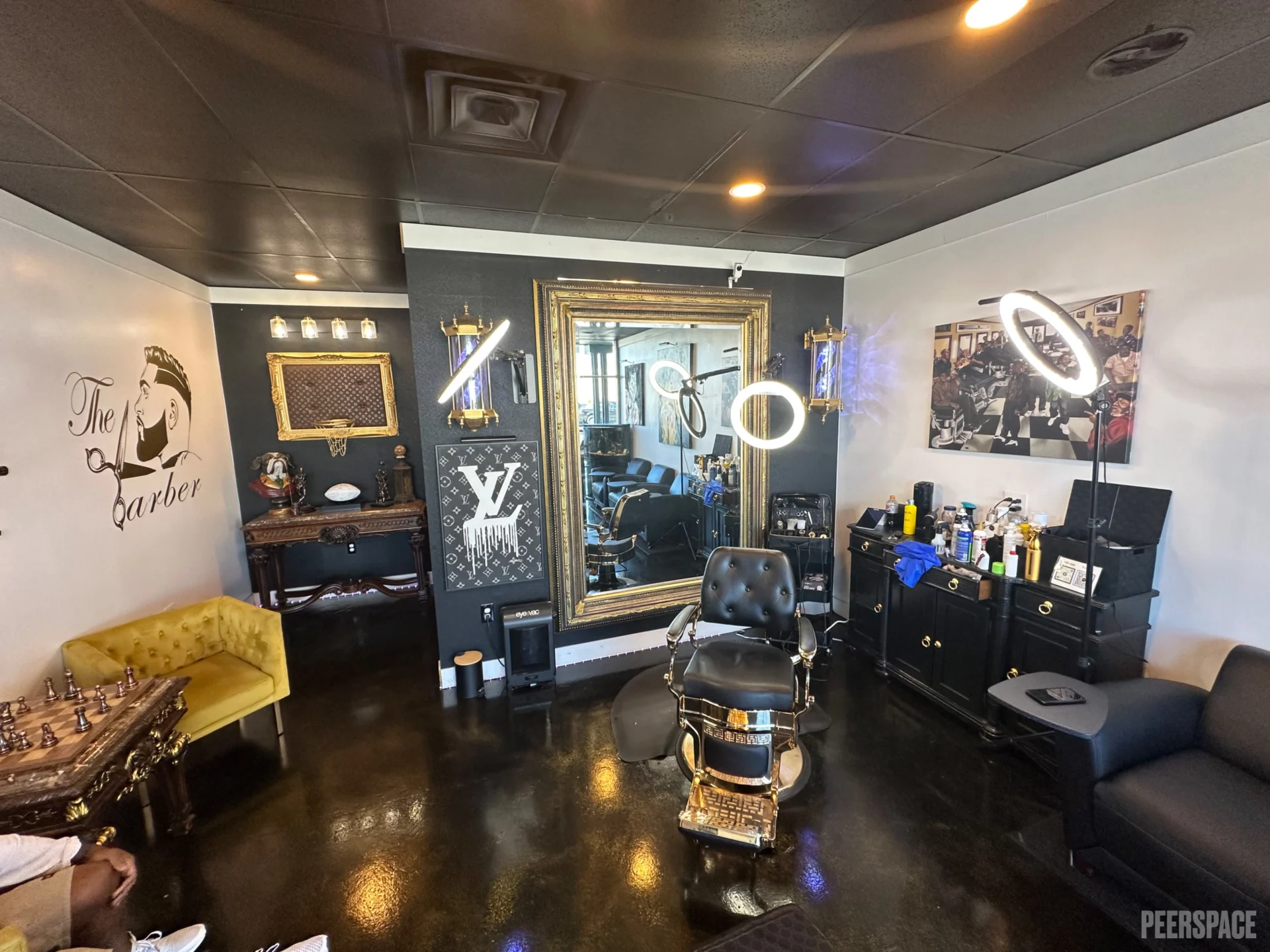Interior view of Mel's Barbershop featuring vintage leather barber chairs, classic mirrors, warm wood paneling and old-school masculine decor