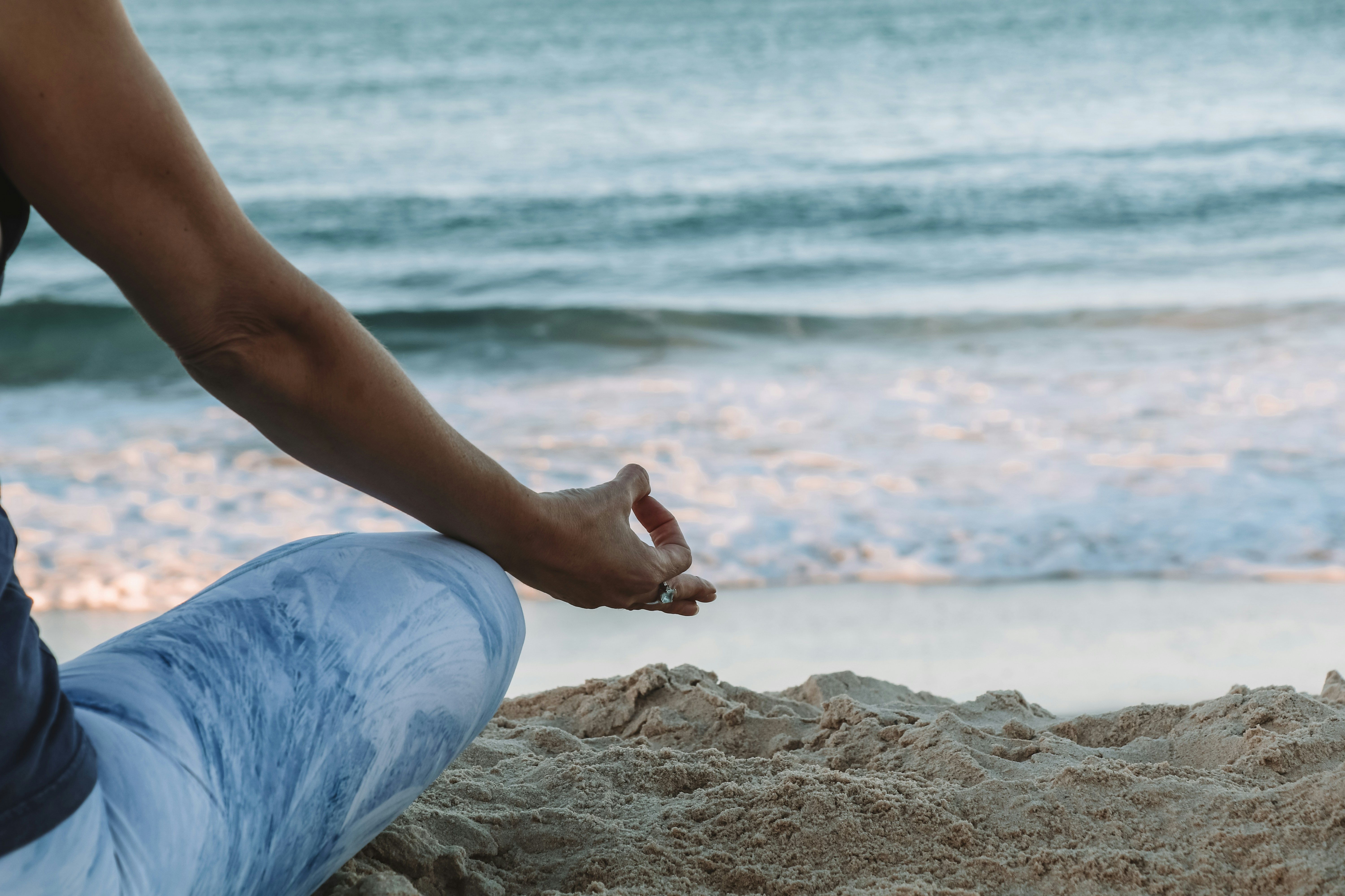 Woman sitting peacefully in a lush natural environment practicing Ayurvedic mindfulness