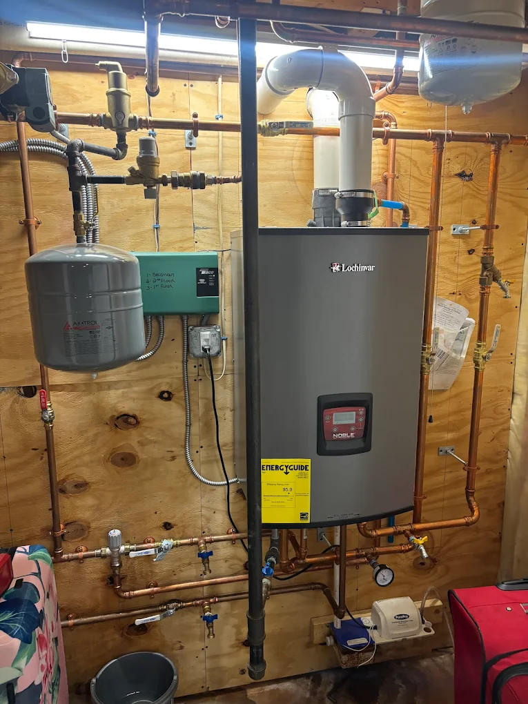 Professional installing a modern high-efficiency furnace heating system