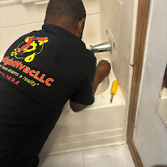 Plumber fixing pipes under a residential kitchen sink