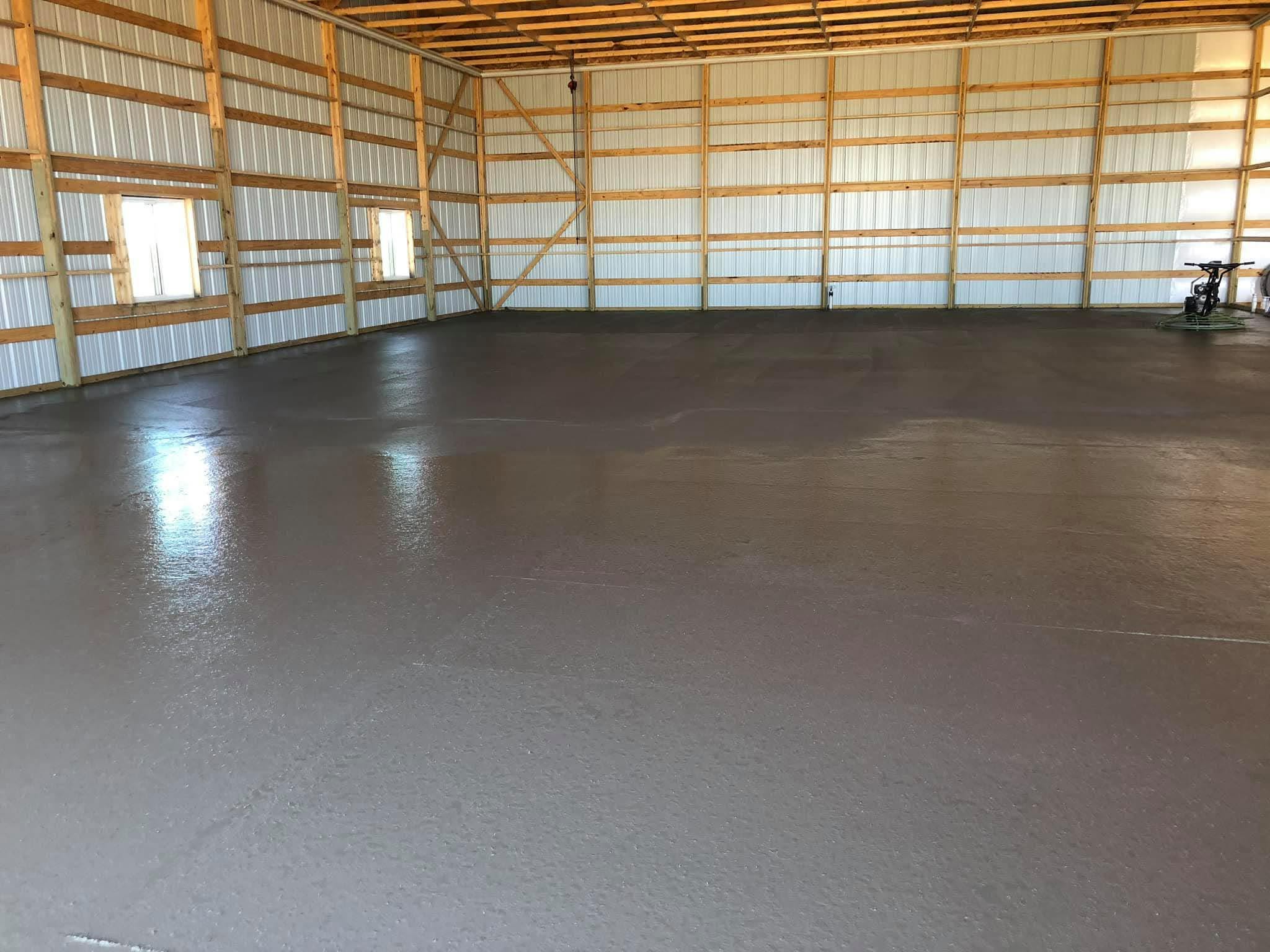 Freshly poured concrete driveway installation with smooth finish by J's Home Repair
