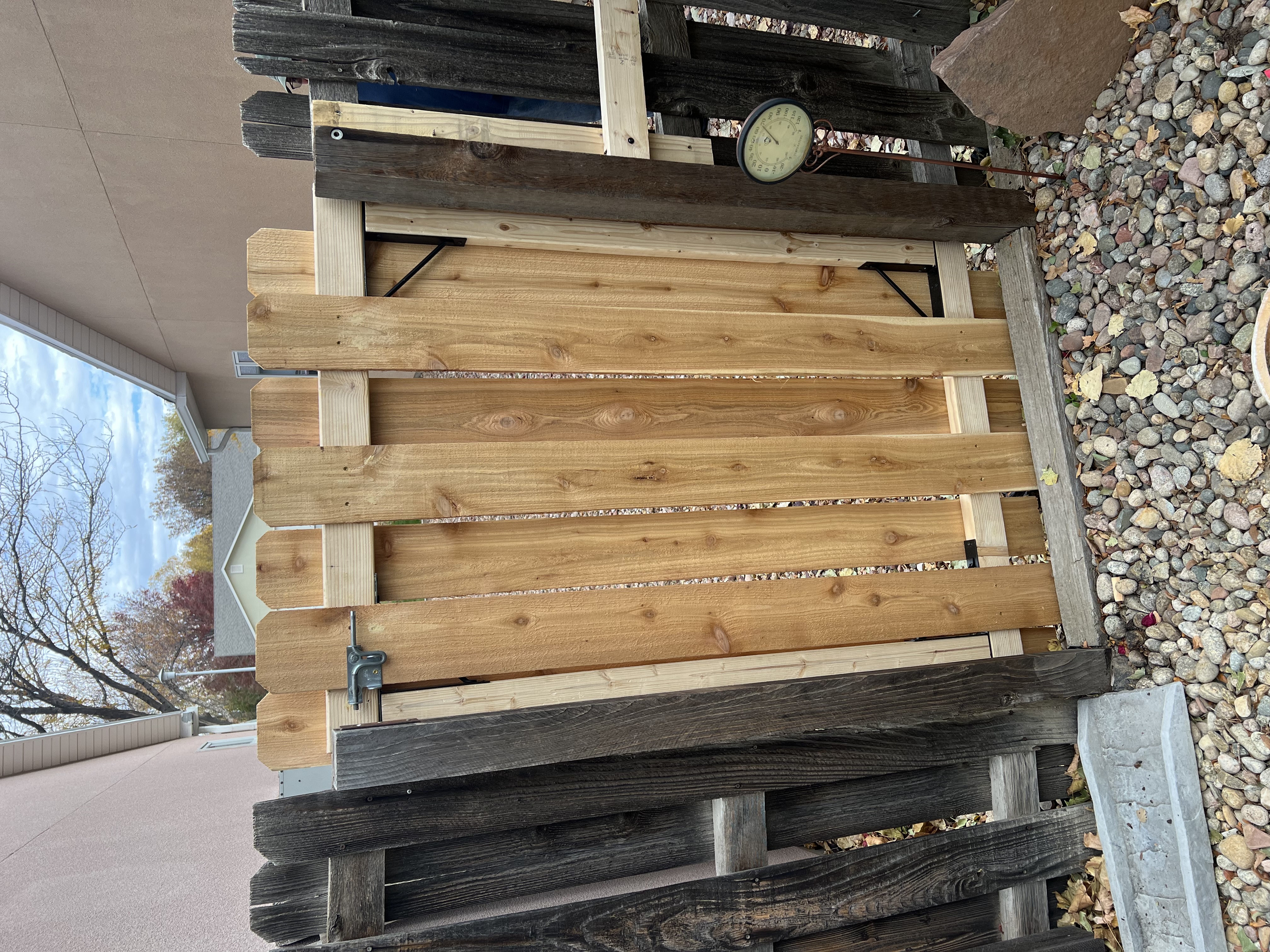 Custom cedar wood privacy fence installation in residential backyard by J's Home Repair