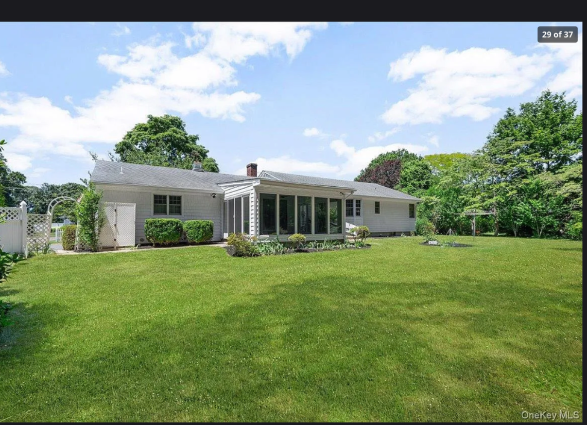 Expansive 0.51-acre lot surrounding 870 Crittens Lane, Southold — offering privacy, open outdoor space, and room to garden or entertain on the North Fork