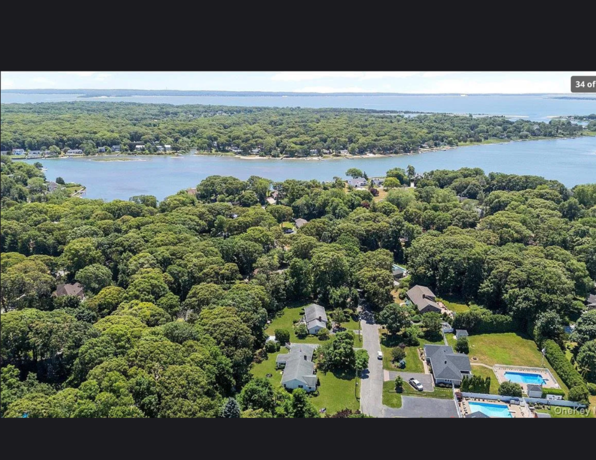 Charming single family home at 870 Crittens Lane, Southold with manicured lawn and classic mid-century architecture