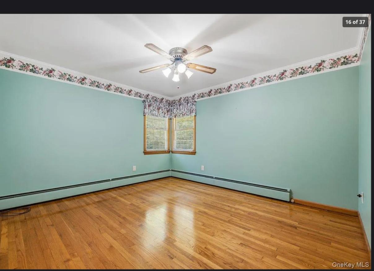 Serene master bedroom at 870 Crittens Lane, Southold — showcasing hardwood floors, tranquil natural light, and comfortable proportions in this classic 3-bedroom North Fork home