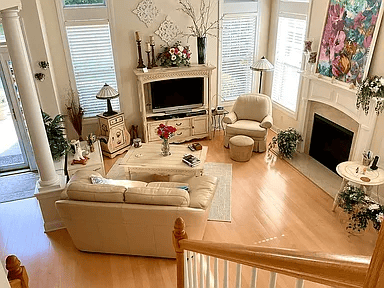 Cozy living room with a grand stone fireplace and exposed wood ceiling beams