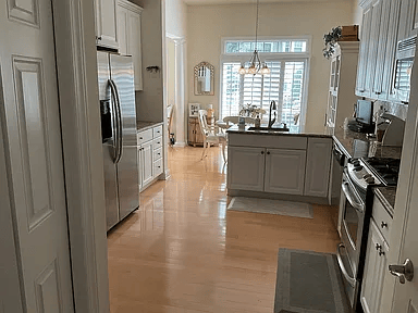 Gourmet kitchen featuring dark wood cabinets, a central island, and aged brass fixtures