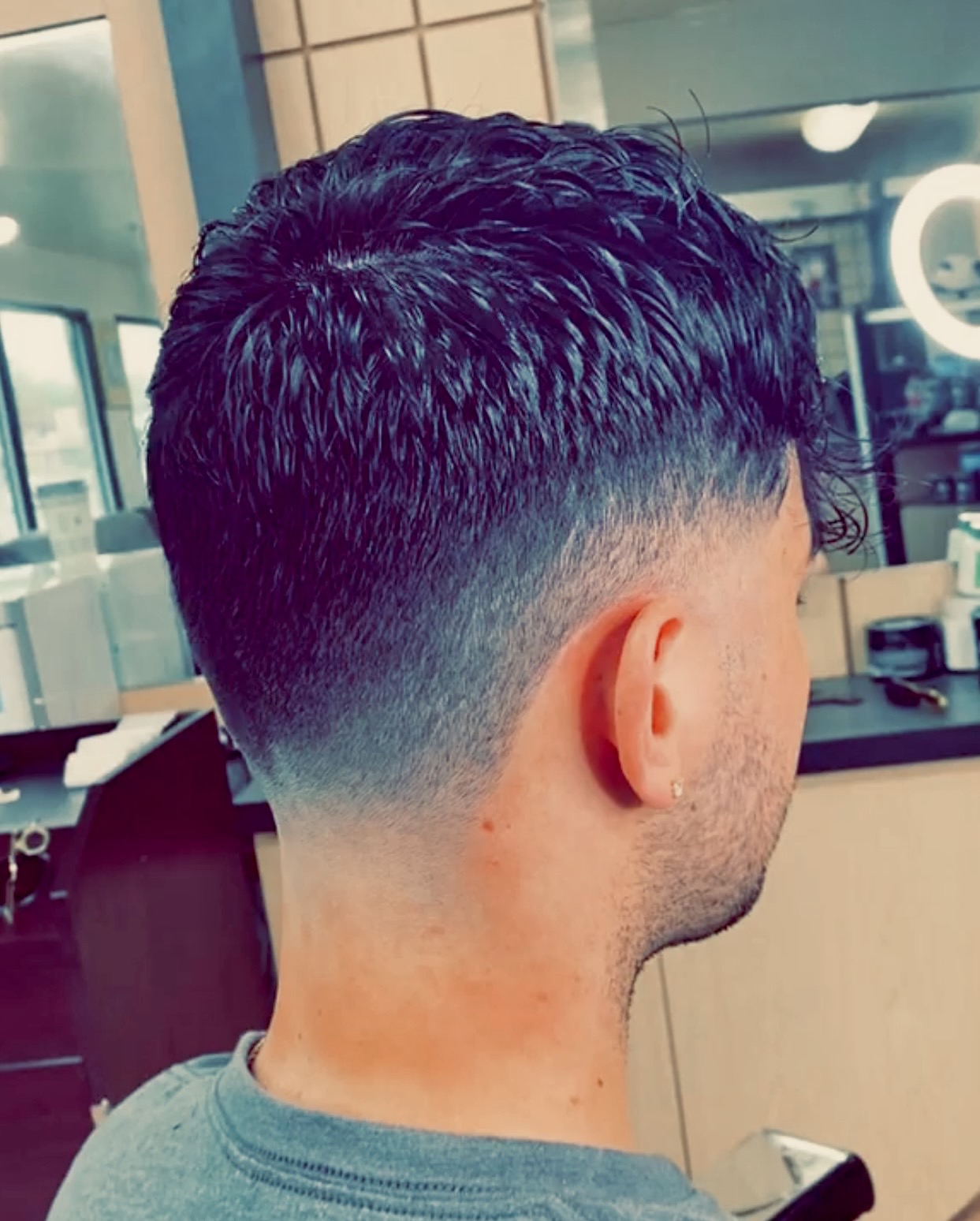 A happy client showing off his new haircut