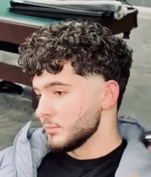 Side profile of a clean modern haircut