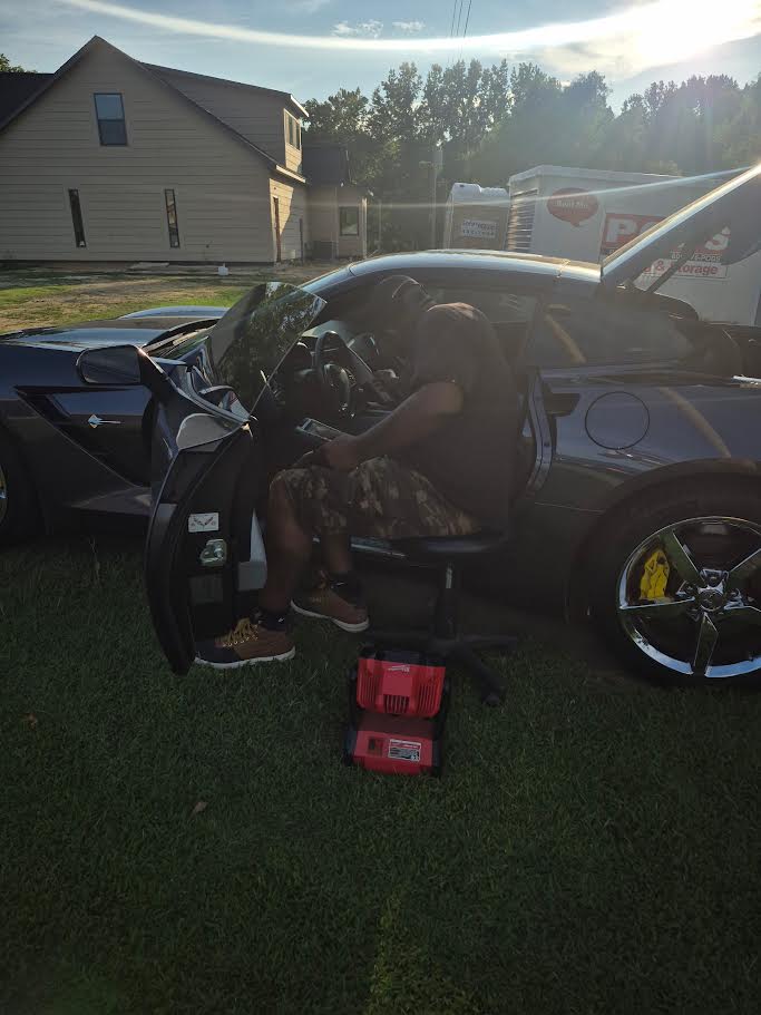 Mr. Get In Mobile Key Service locksmith working inside a customer's car
