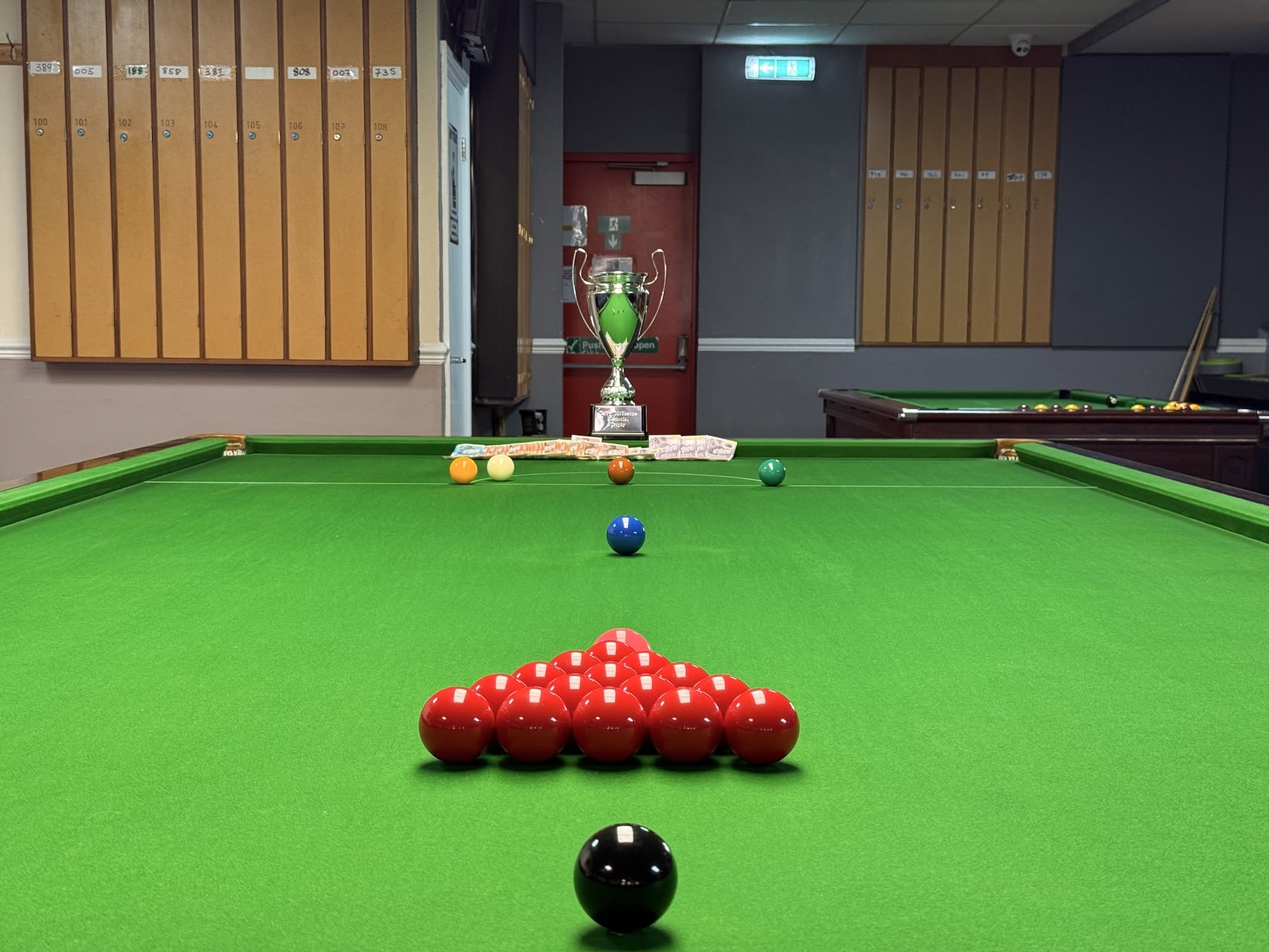 Close-up shot of a player taking a precise shot on a pristine snooker table