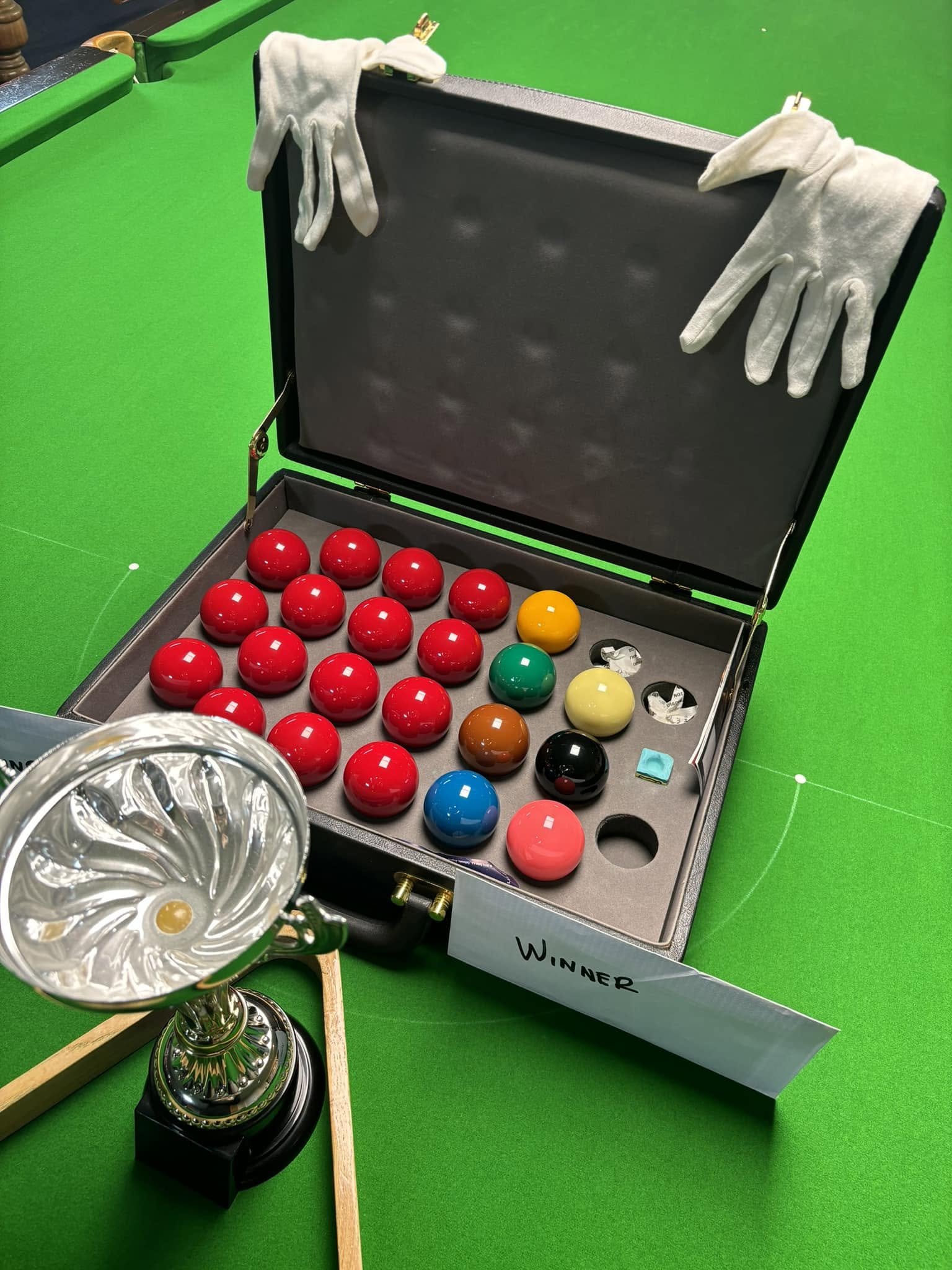 Close-up of polished snooker balls arranged on the green baize before a game