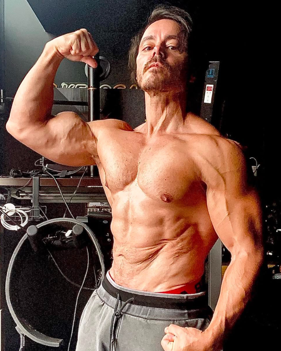 Professional headshot of a male physique coach with a beard