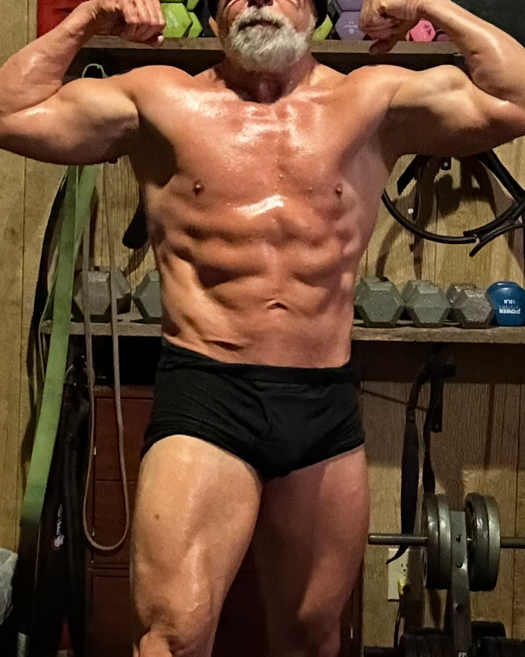 After transformation photo of male competitor Derek on day sixty showing chiseled abs vascular arms and competition ready lean muscular fizeek