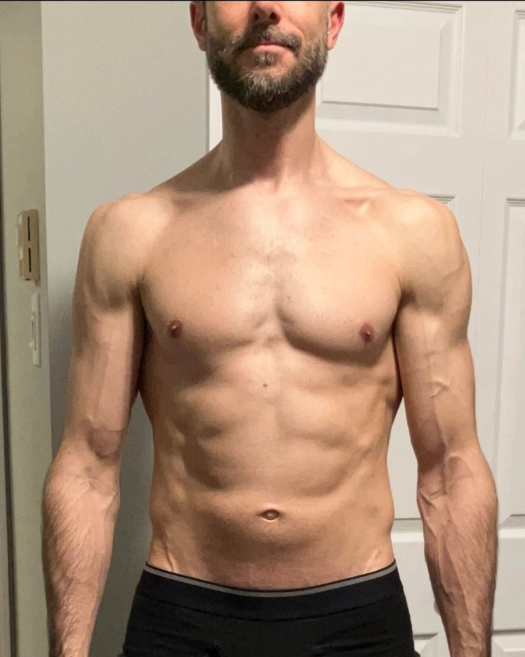 After transformation photo of male competitor Anthony G showing lean muscular shredded abs as a top 5 finisher in the FIZEEK FREEK challenge